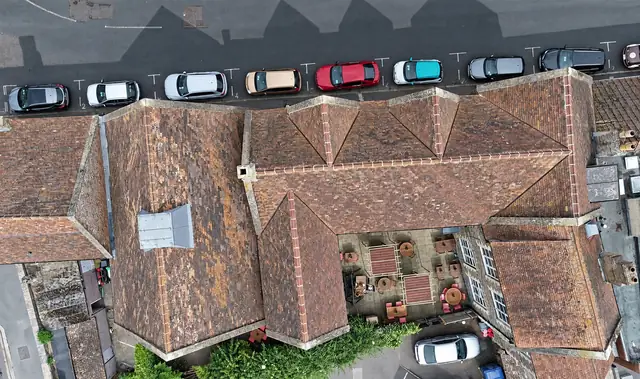 Top-down drone survey view of clay tiled roofs in a town centre