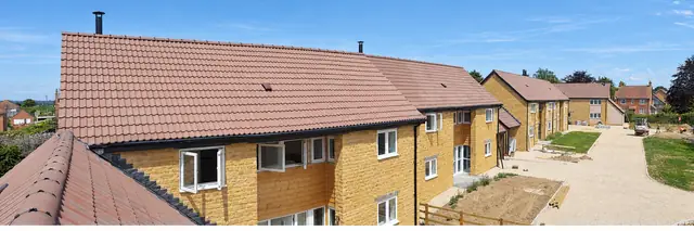 Panoramic view of new-build homes with clay tiled roofs